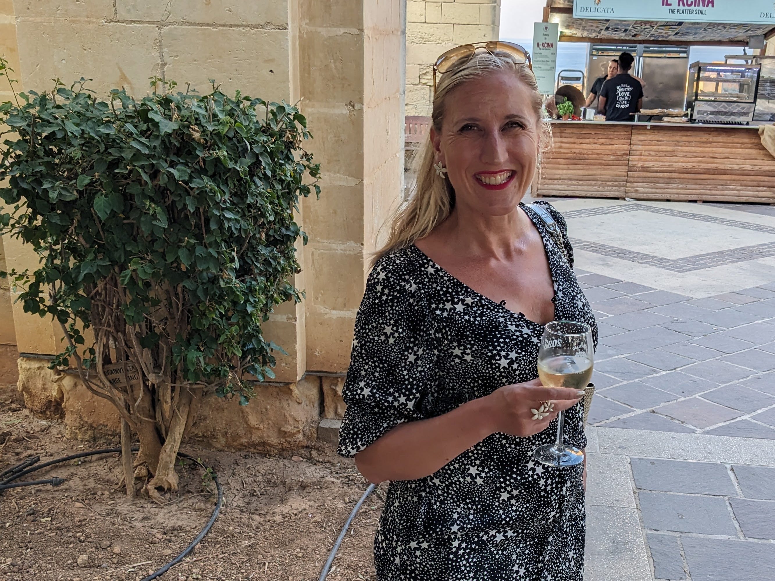 Author Louise Slyth smiling with glass of wine