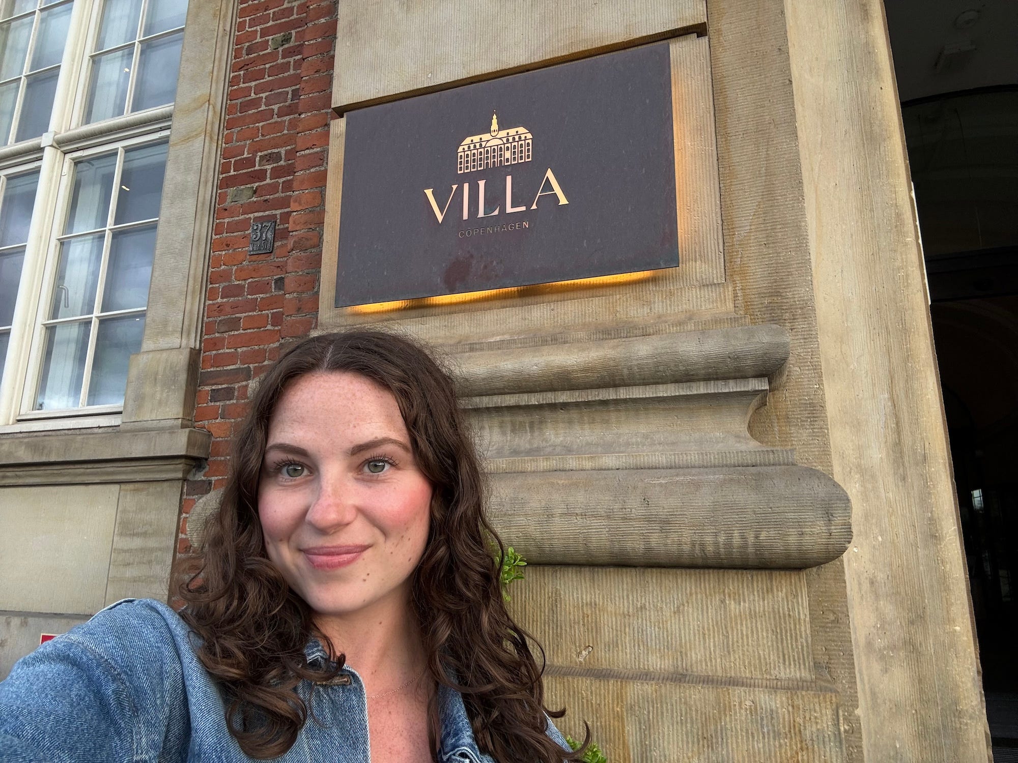 A selfie of a woman inside of a sign that reads