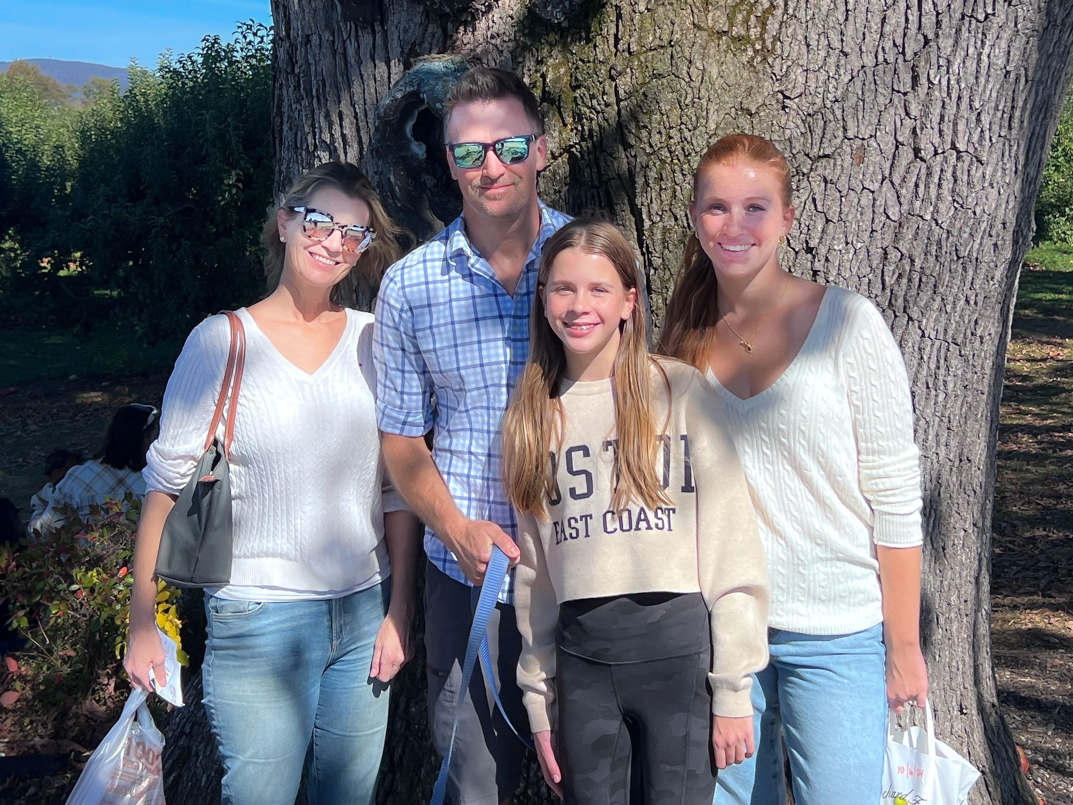 The author poses outdoors with her family.