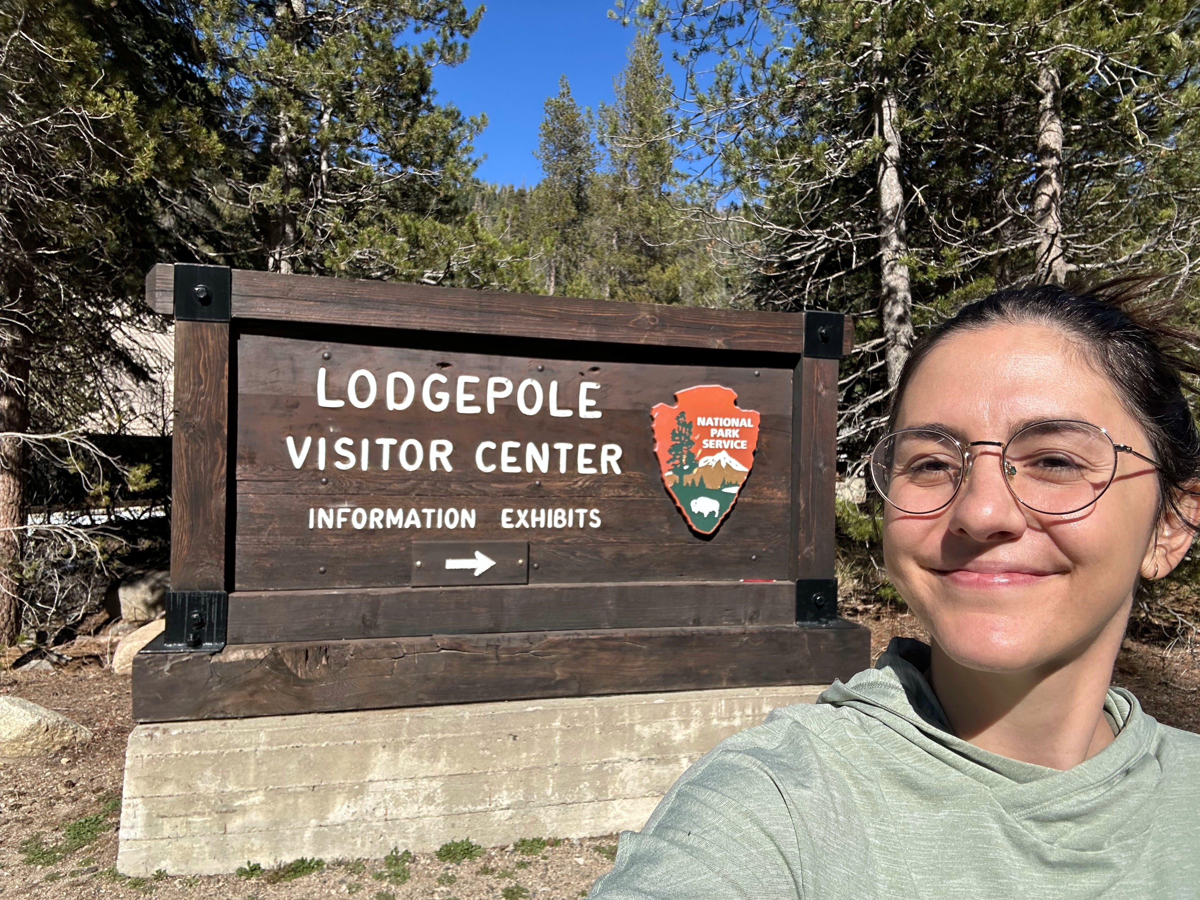 Selfie of the author in front of a visitor center sign.