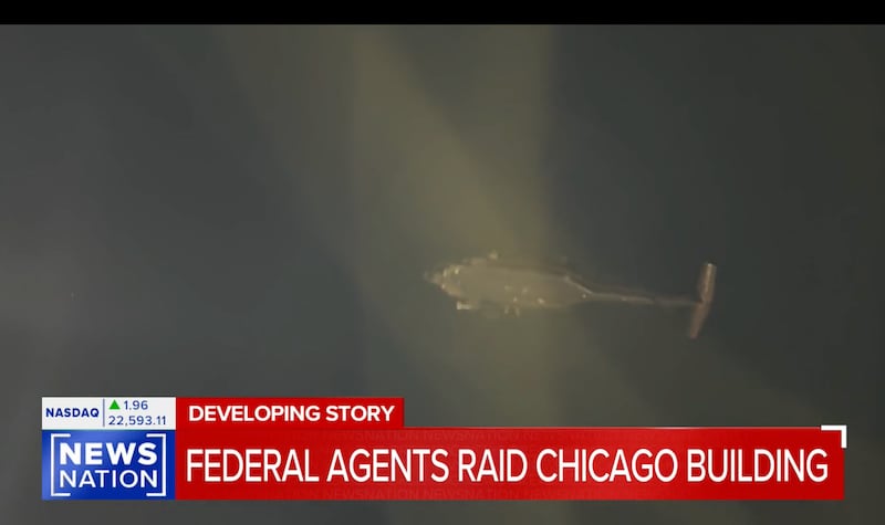 A helicopter flies overhead during an ICE raid in Chicago on early Tuesday morning.