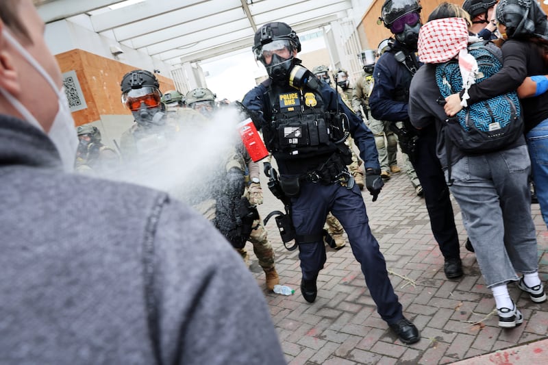 PORTLAND, OREGON - OCTOBER 04: Federal agents, including members of the Department of Homeland Security, the Border Patrol, and police, clash with protesters outside a downtown U.S. Immigration and Customs Enforcement (ICE) facility on October 04, 2025 in Portland, Oregon. The facility has become a focal point of nightly protests against the Trump administration and his announcement that he will be sending National Guard troops into Portland. A federal judge is currently hearing Oregon’s case against sending troops into the city, and a decision is expected on Saturday.  (Photo by Spencer Platt/Getty Images)