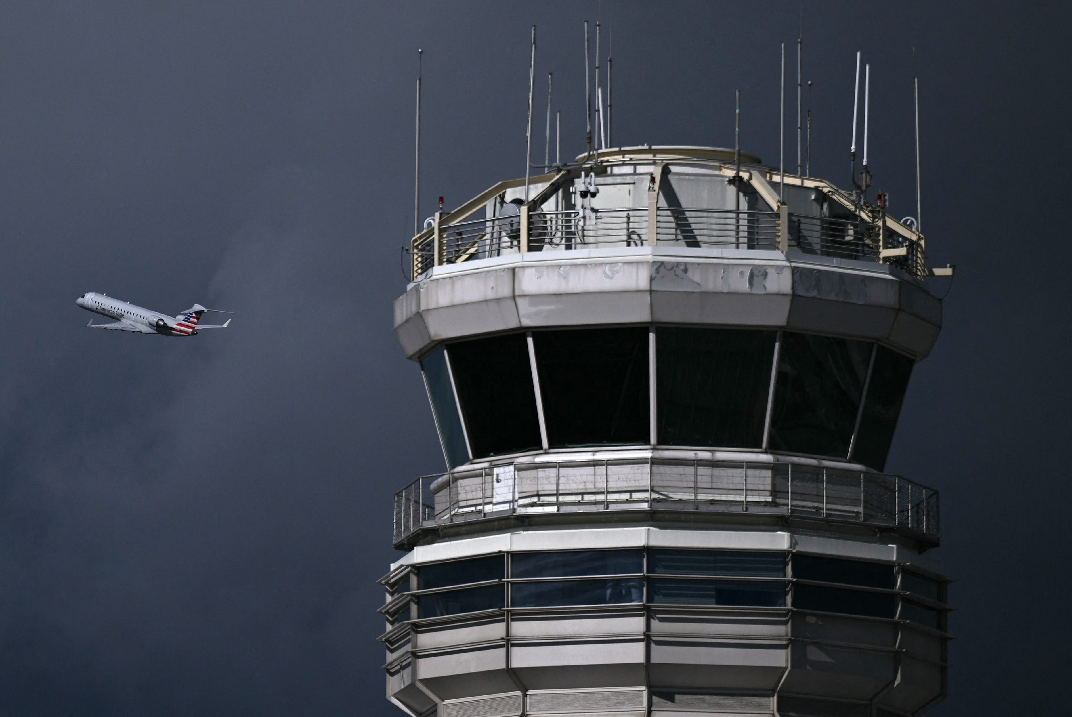 An airplane takes off near the control tower at Reagan National Airport in Arlington, Virginia, on October 8, 2025.