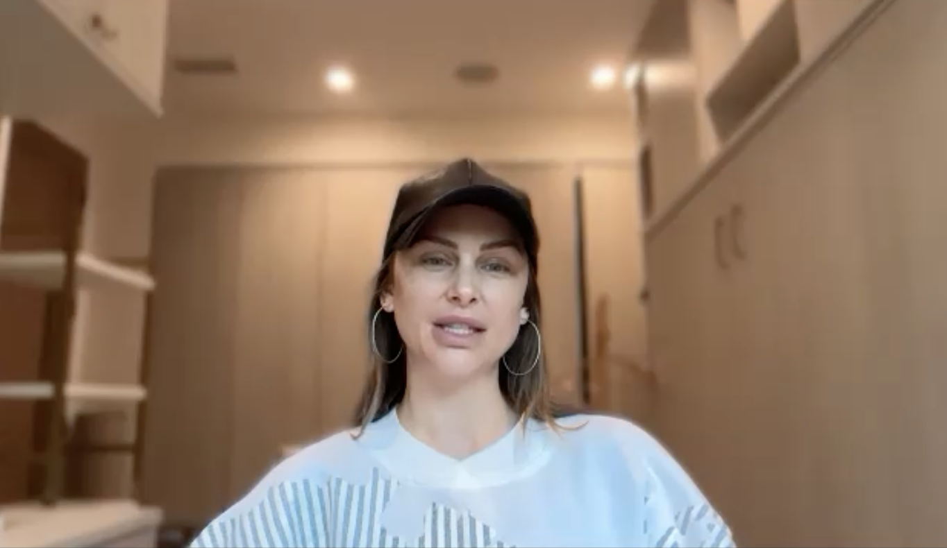 Lala Kent with a black baseball cap and hoop earrings.