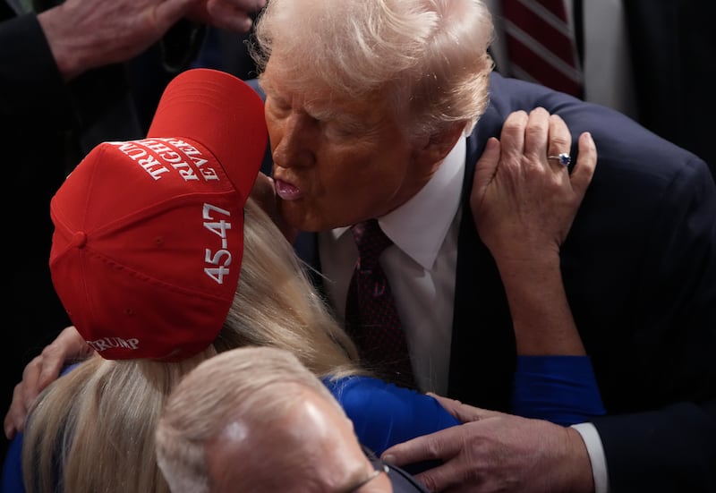 Rep. Marjorie Taylor Greene gives President Donald Trump a kiss after he addressed a joint session of Congress on March 04, 2025. While she has been critical of the party of late, the Georgia lawmaker insists she still backs Trump.