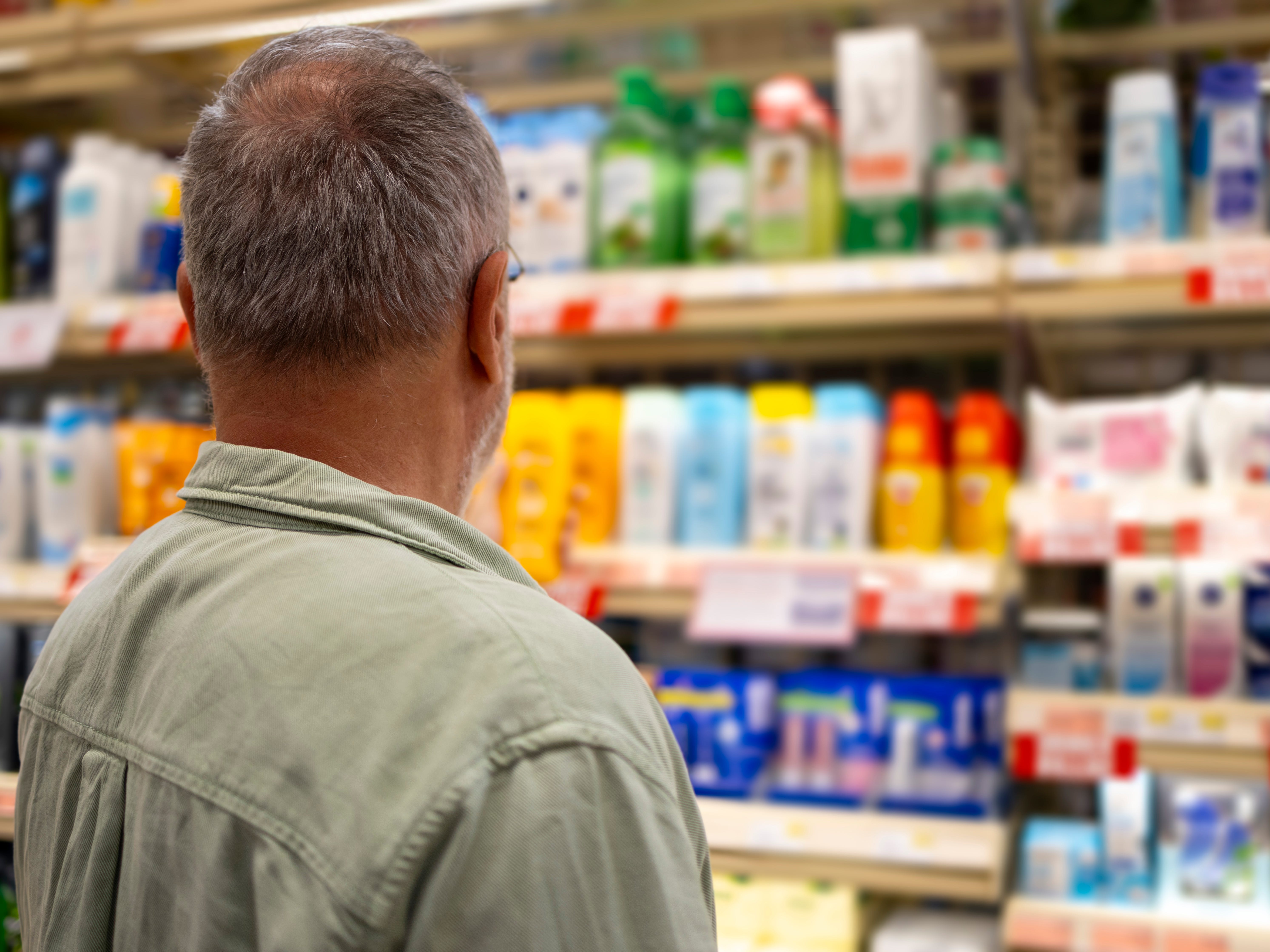 The back of a man in a store