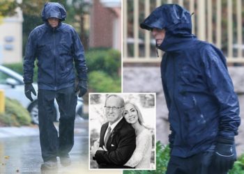 Mitt Romney’s despondent brother strolls through rain days after estranged wife found dead