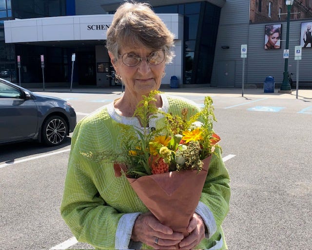 The author's mother holding fowers from the farmer's market.