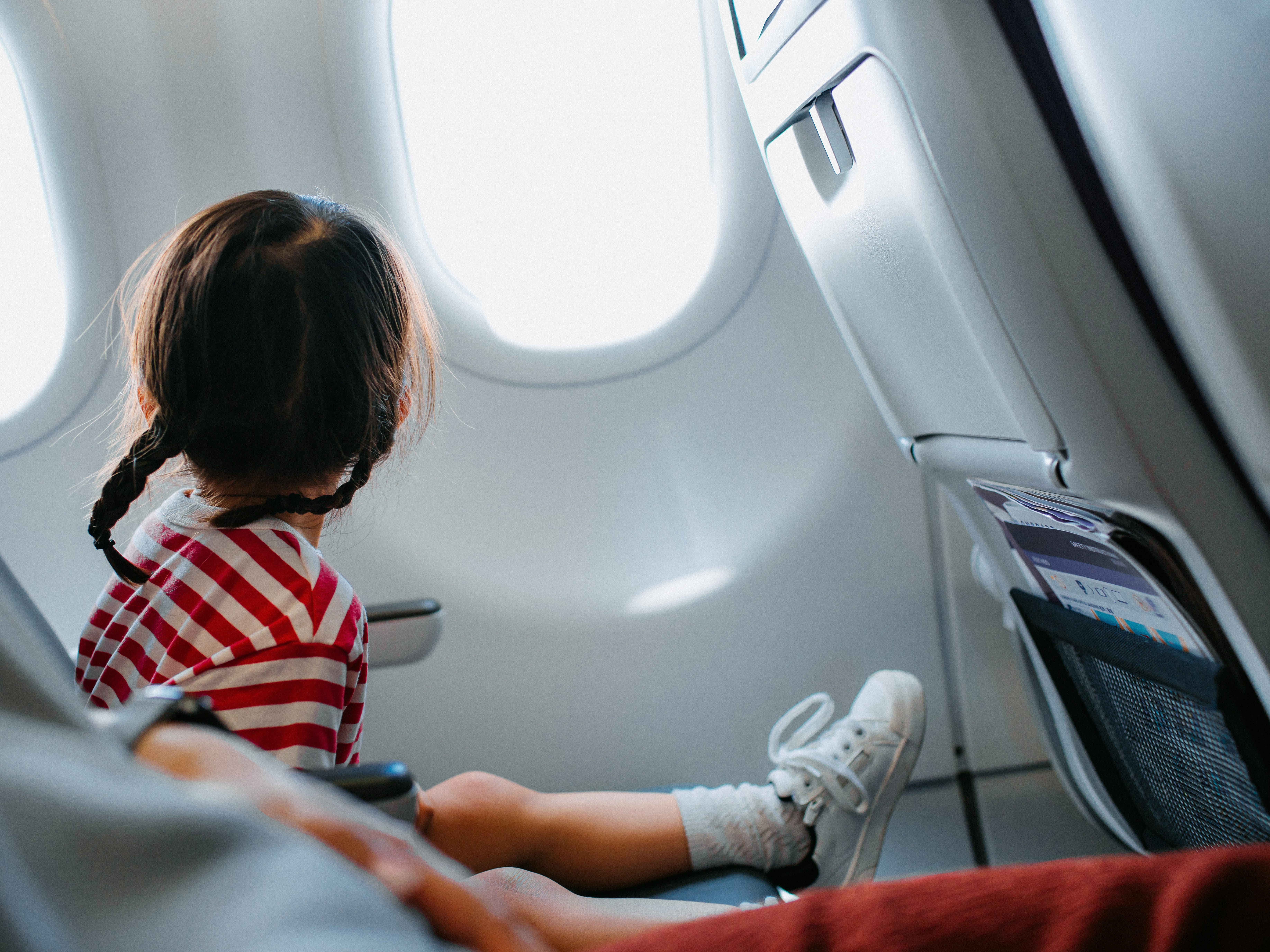 a little girl sitting on a plane
