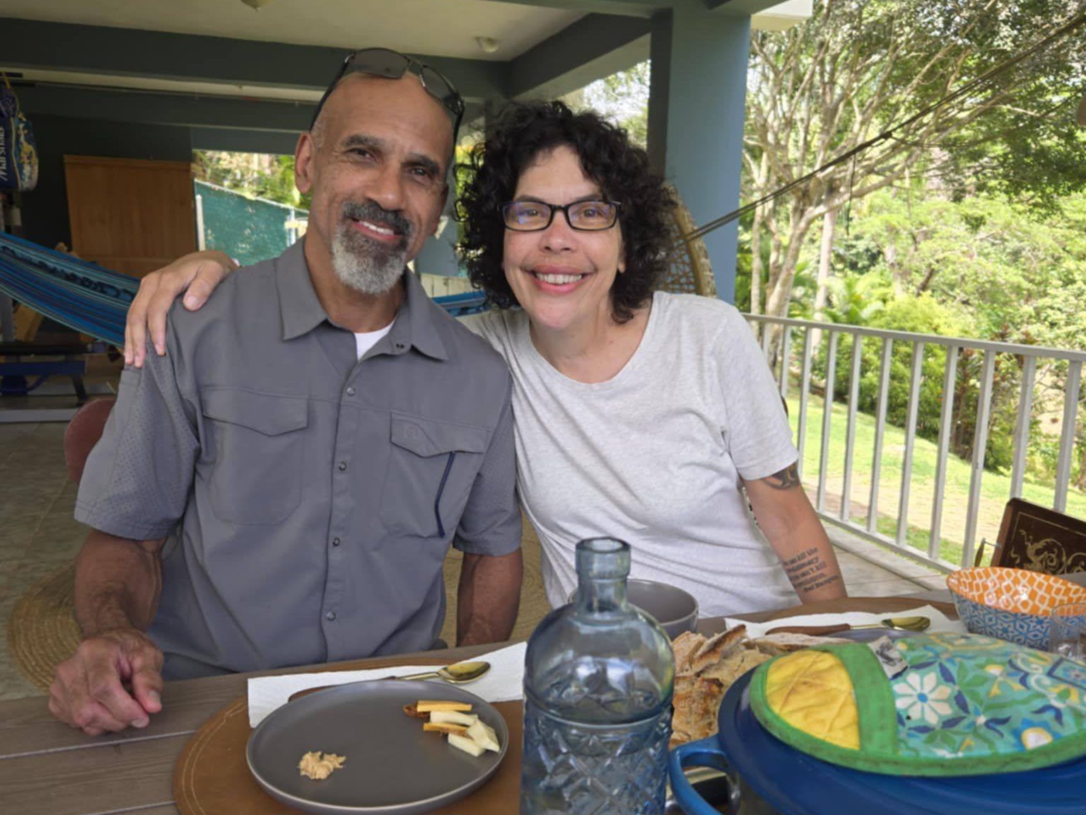 The author and her husband pose while dining outdoors.
