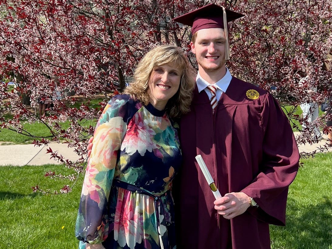 Katy M. Clark and her son in a graduation gown