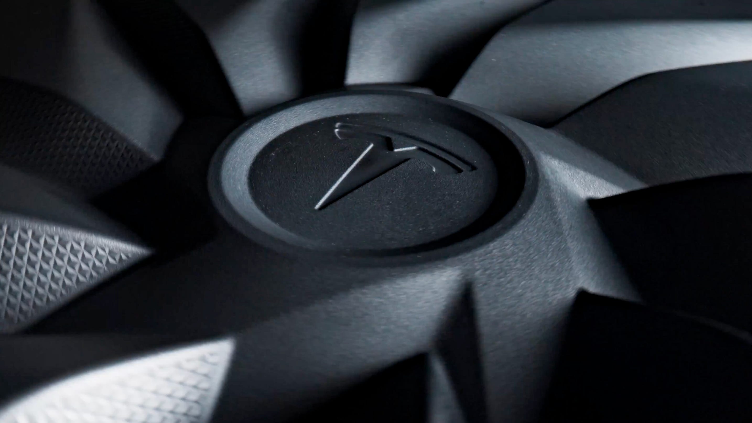 A Tesla teaser is pictured.