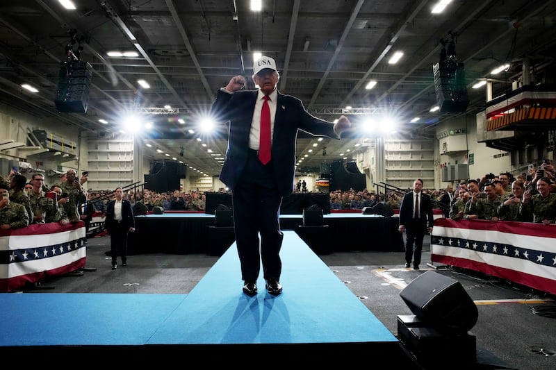 President Donald Trump dances as he prepares to depart after speaking to troops aboard the USS George Washington on October 28, 2025 in Yokosuka, Japan.