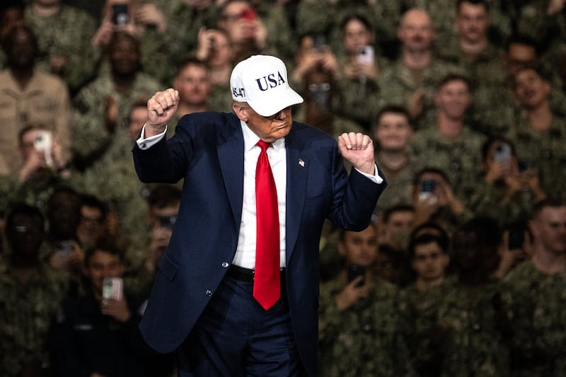 President Donald Trump dances as he leaves after delivering a speech in front of U.S. Navy personnel on board the USS George Washington aircraft carrier in Yokosuka, Japan on October 28, 2025.