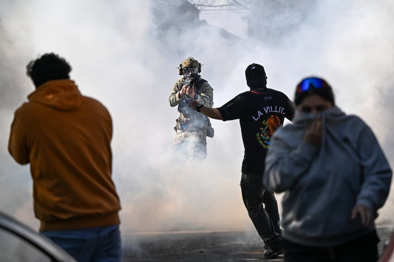 CHICAGO, ILLINOIS - OCTOBER 14: Residents and protesters clash with federal agents in the East Side neighborhood on October 14, 2025 in Chicago, Illinois. It was not immediately clear why federal agents were in the area but people on social media reported Immigration and Customs Enforcement agents arrested an individual and caused a car accident. Last week a Federal judge put in place a temporary order preventing the 500 National Guard troops that were sent to the Chicago and surrounding suburbs to help protect ICE and other federal agents and federal property. President Donald Trumps's administration continues to enforce immigration laws in Chicago and the surrounding suburbs during their