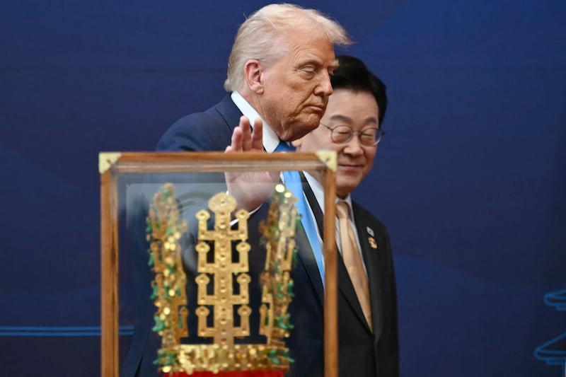 US President Donald Trump walks with South Korean President Lee Jae Myung during a high honor presentation ceremony, where Trump was presented with a replica of a crown worn by the kings of Silla, at the Gyeongju National Museum in Gyeongju on October 29, 2025.