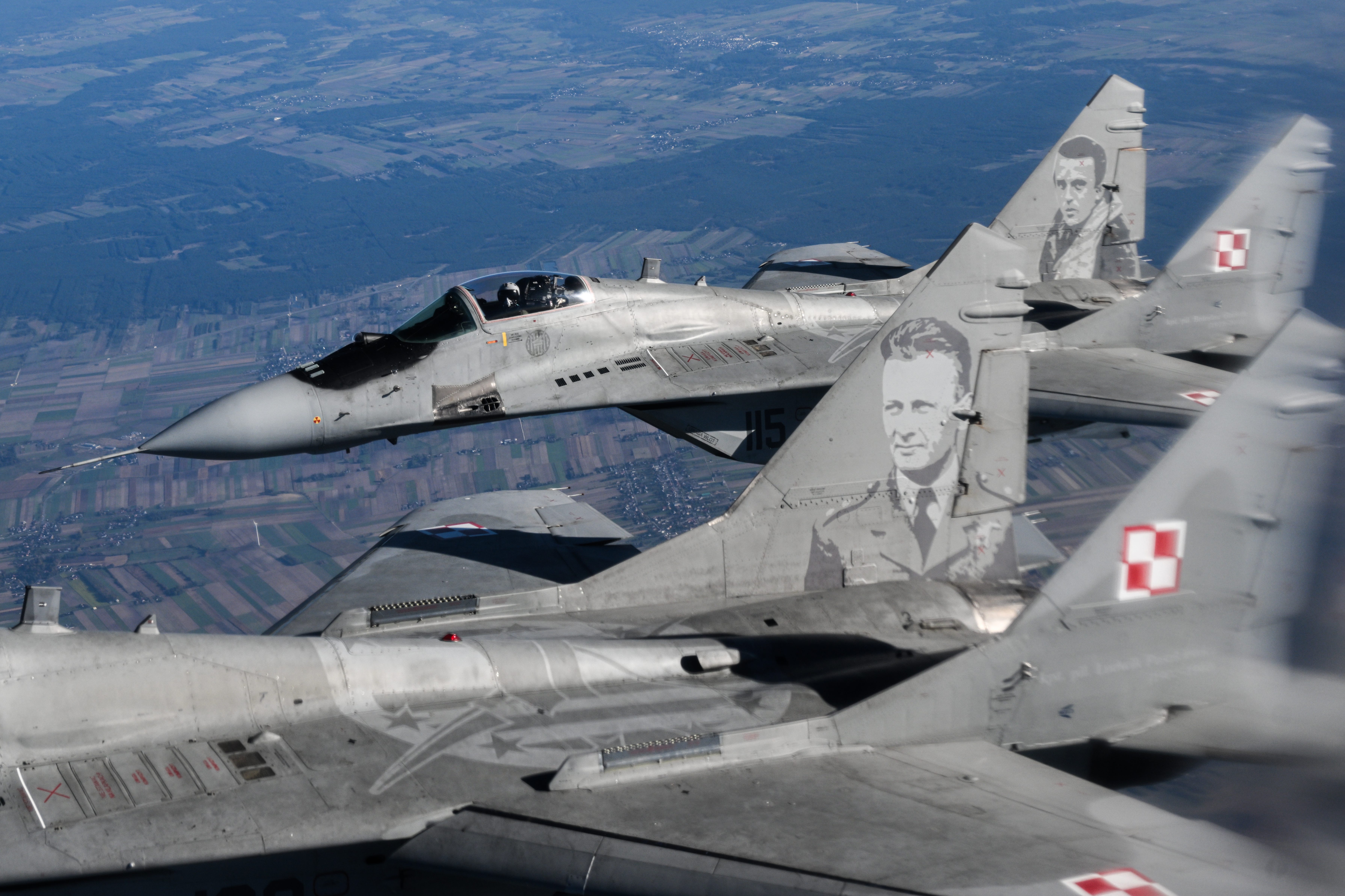 Two MiG-29 fighters fly side-by-side.