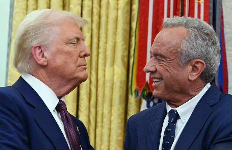 The new US Secretary of Health and Human Services Robert F. Kennedy Jr., shakes hands with US President Donald Trump.