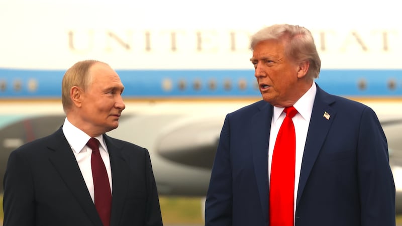 Russian President Putin (L) listens to U.S. President Donald Trump (R) during the welcoming ceremony prior to the meeting on war in Ukraine