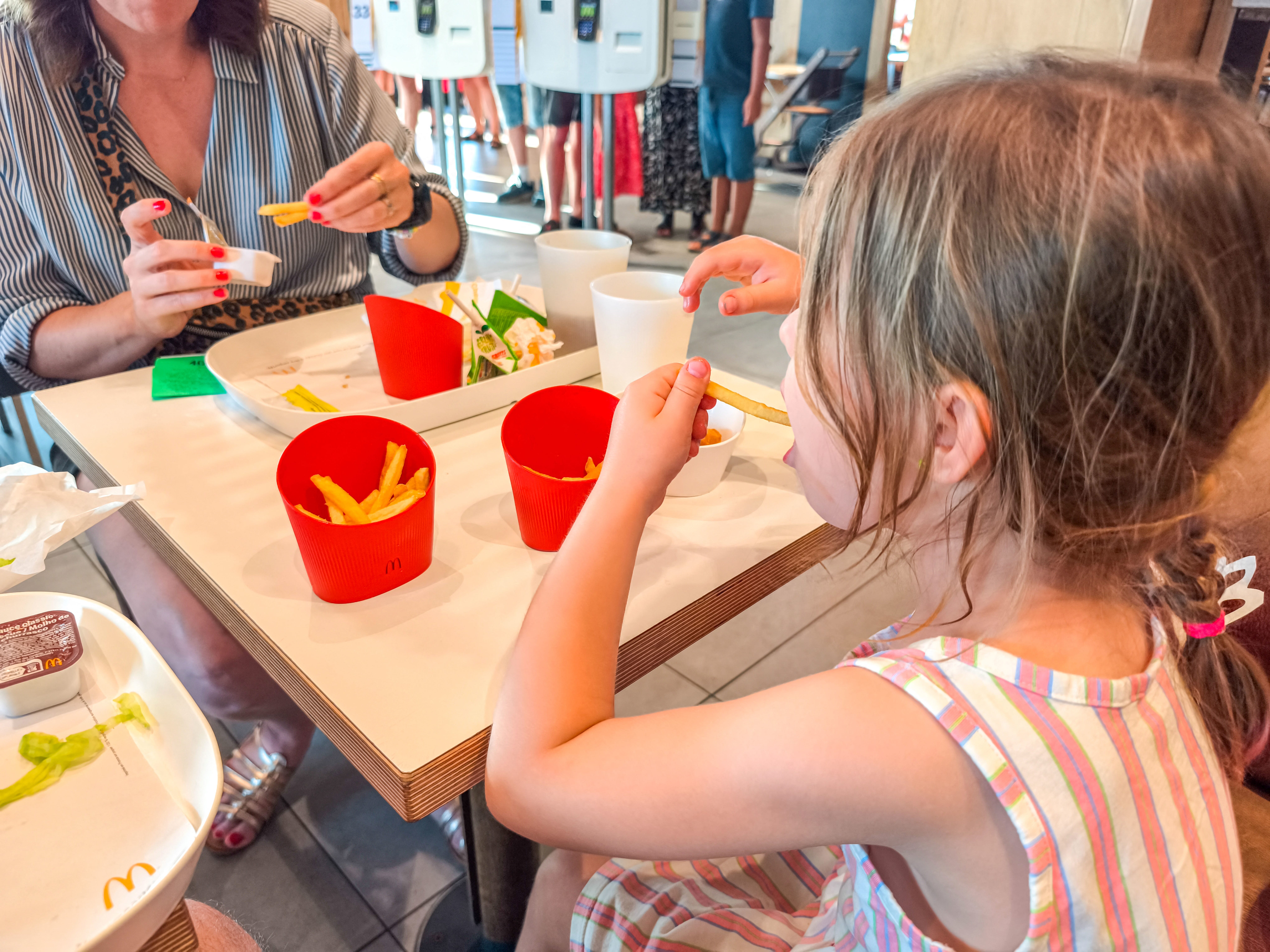 A mother and child dine at a restaurant.