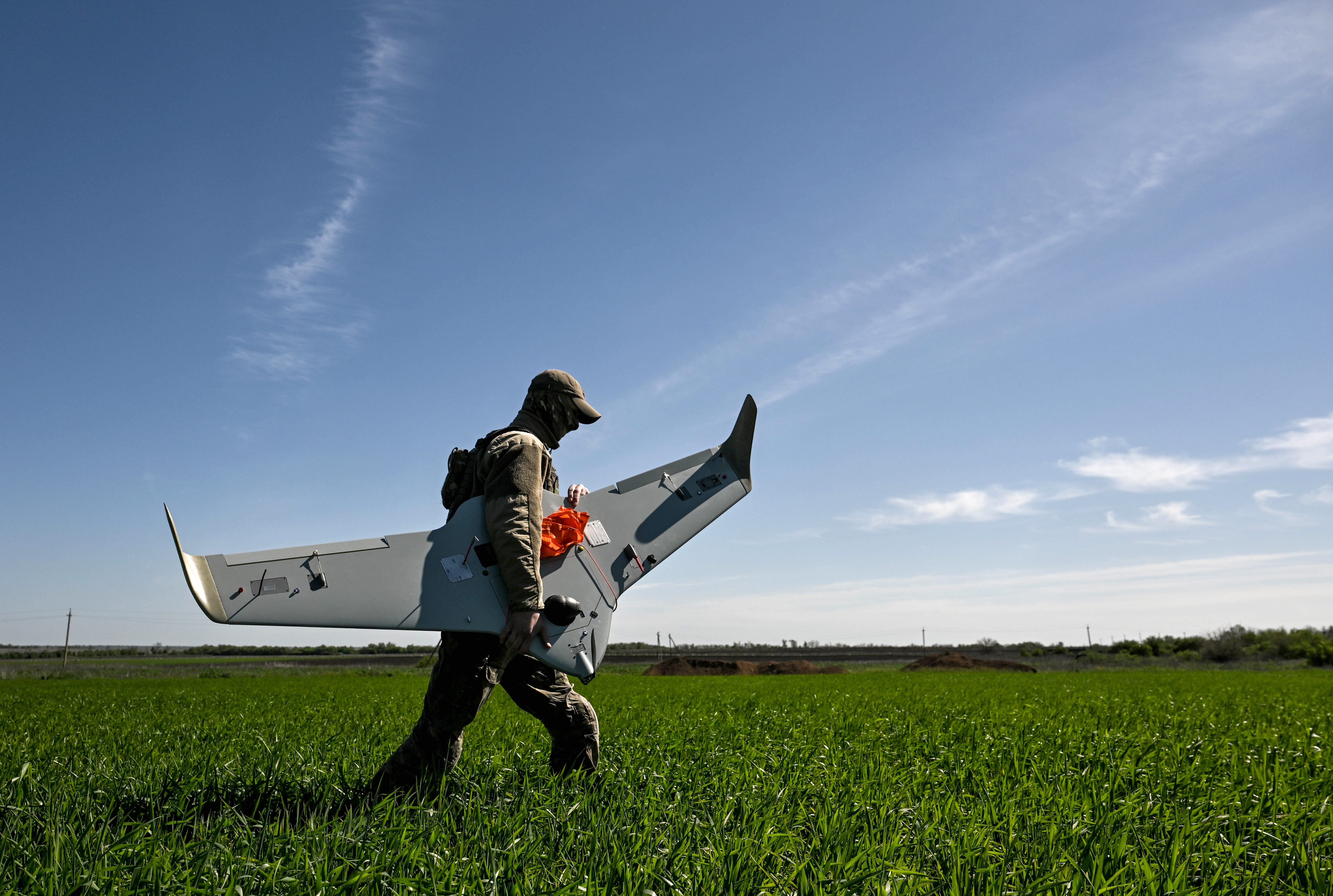 A Ukrainian serviceman carries a Domakha reconnaissance drone, Donetsk region, Ukraine, on May 2, 2025.