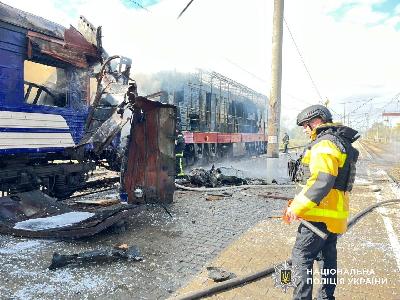 Firefighters work next to a passenger train hit by today's Russian drone strike, amid Russia's attack on Ukraine, at the railway station in the town of Shostka, Sumy region, Ukraine October 4, 2025.