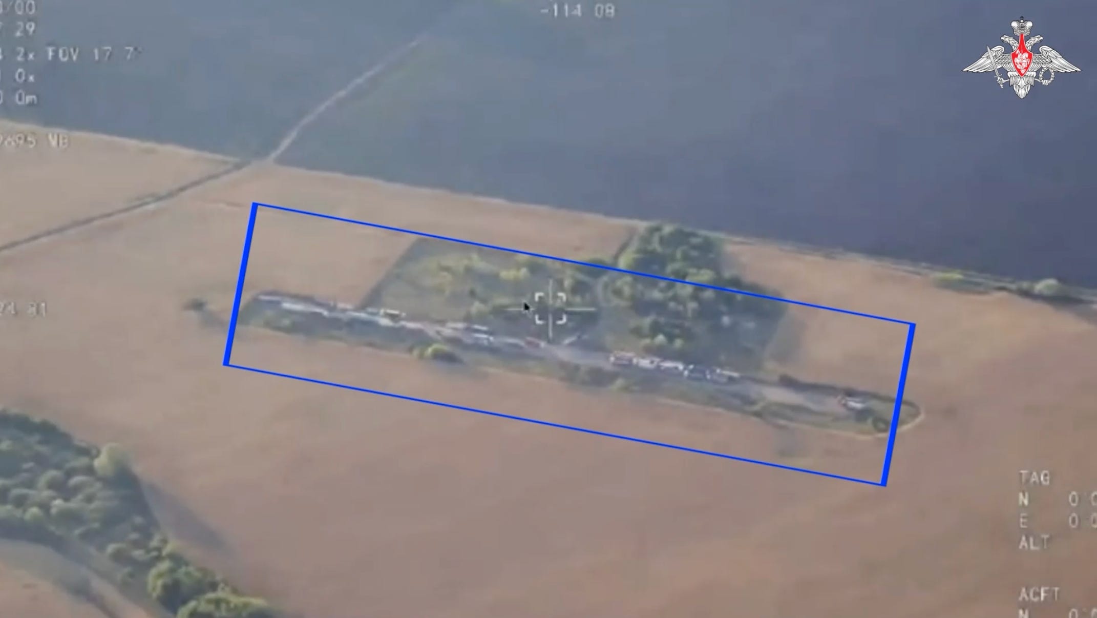 An overhead view of Ukrainian trucks parked next to a field.