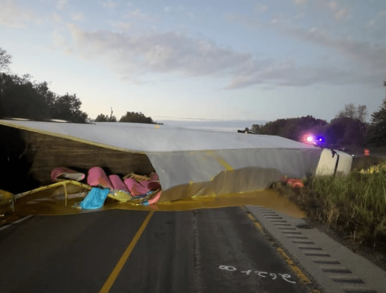 An overturned semi-truck spills applesauce out of its trailer after crashing on I-57 in Illinois on Oct. 6, 2025.