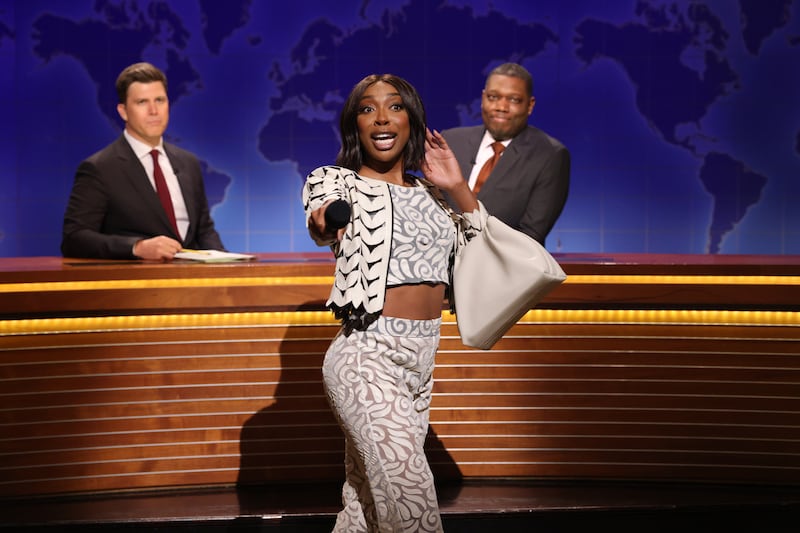 SATURDAY NIGHT LIVE -- Episode 1884 -- Pictured: (l-r) Anchor Colin Jost, Ego Nwodim as Miss Eggy, and anchor Michael Che during Weekend Update on Saturday, May 17, 2025 -- (Photo by: Will Heath/NBC via Getty Images)