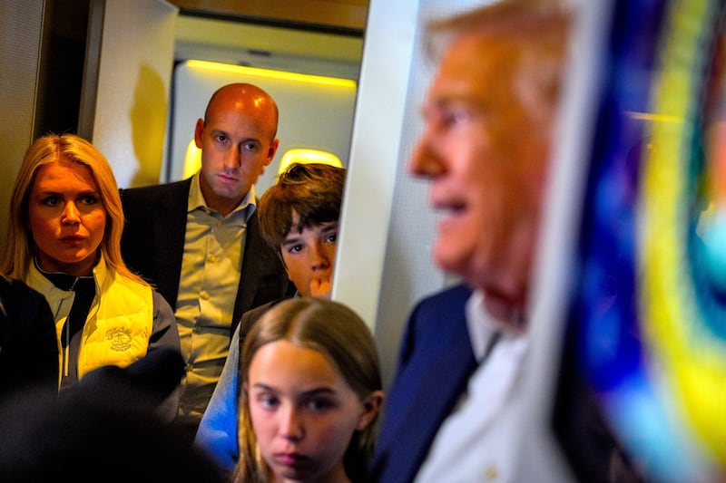 President Donald Trump (R), accompanied by White House press secretary Karoline Leavitt (L), White House Deputy Chief of Staff Stephen Miller