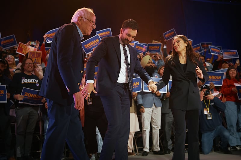 New York Mayoral Candidate Zohran Mamdani (C) salutes with Sen. Bernie Sanders (I-VT), left, and U.S. Rep. Alexandria Ocasio-Cortez (D-NY), right