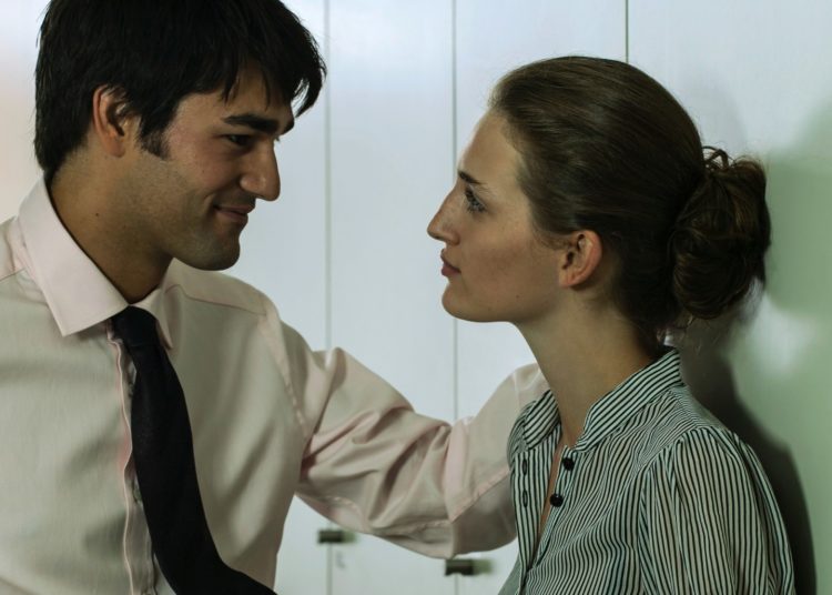 The Do’s and Don’ts of Flirting at Work Without Getting Fired, According to an Expert