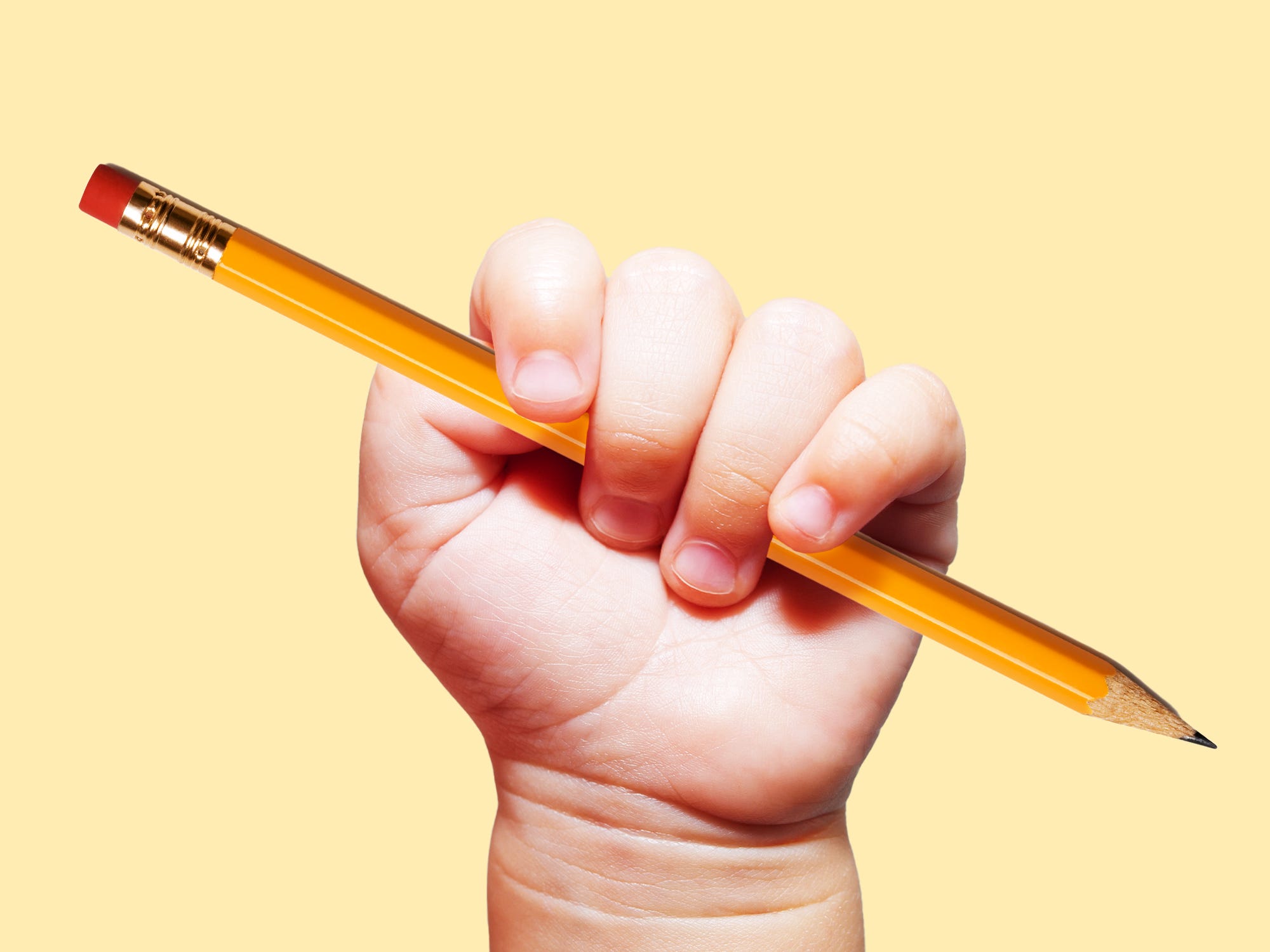 Baby hand holding a #2 Pencil.
