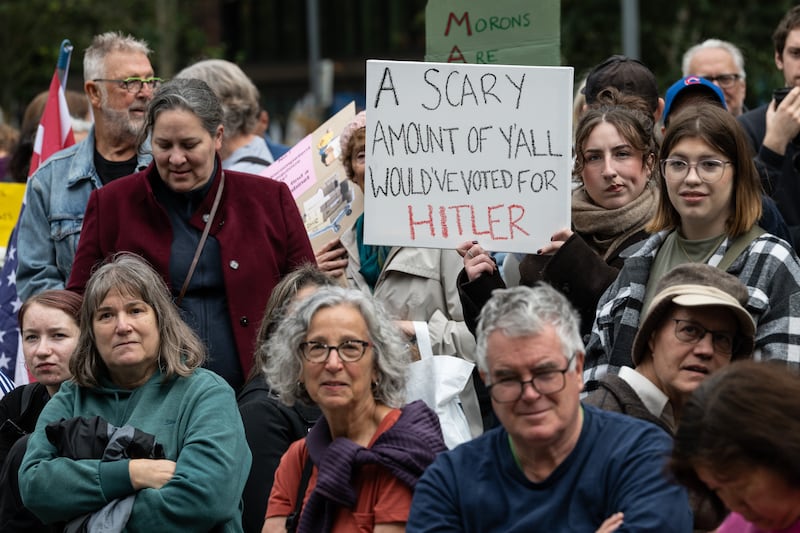 LONDON, ENGLAND - OCTOBER 18: A crowd of mainly American anti Trump protestors holds signs outside the US Embassy London during a "No Kings" protest against U.S. President Donald Trump at on October 18, 2025 in London, England. The protests follow similar "No Kings" events in the United States. (Photo by Guy Smallman/Getty Images)