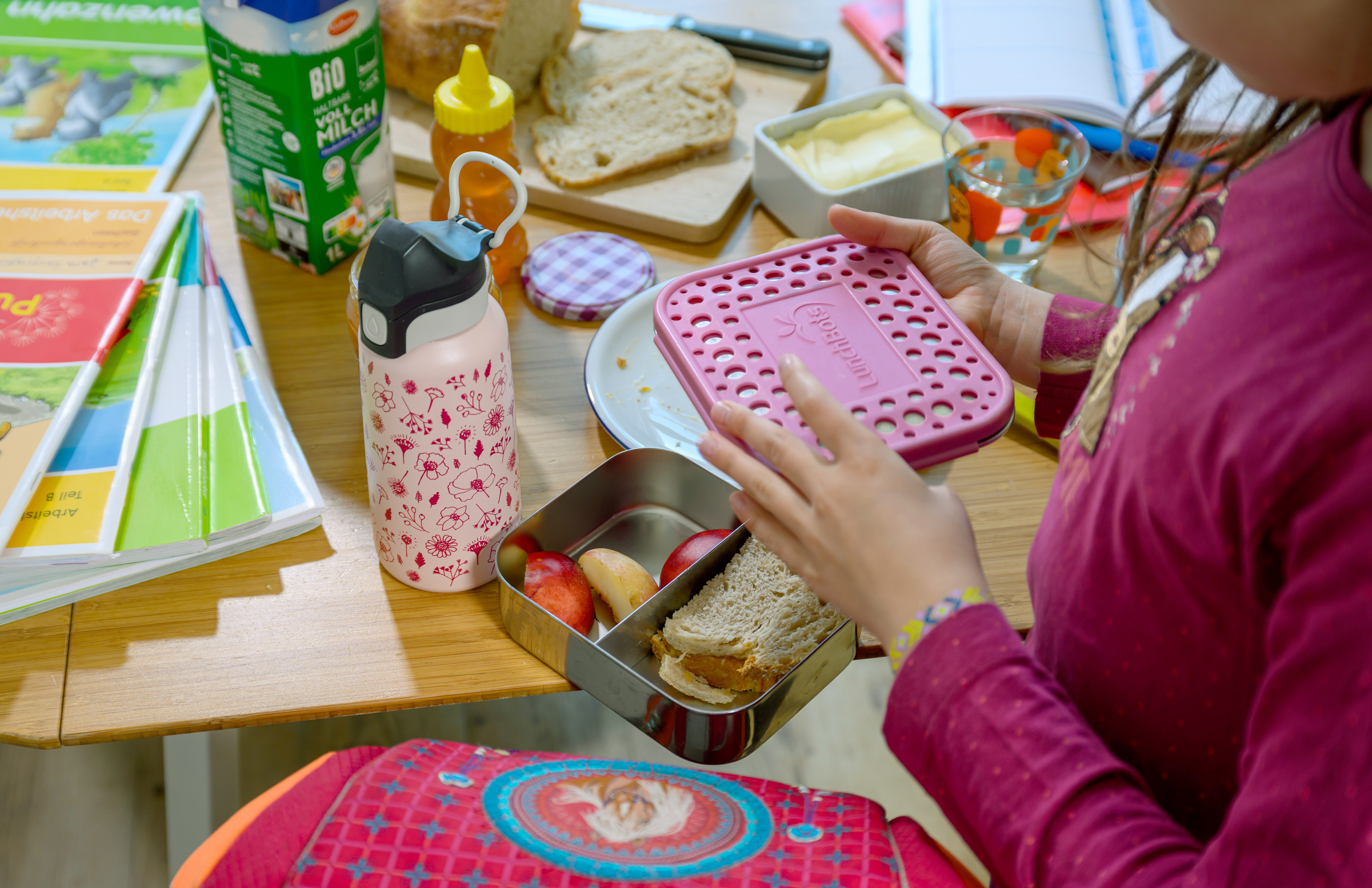 A person holds their lunchbox