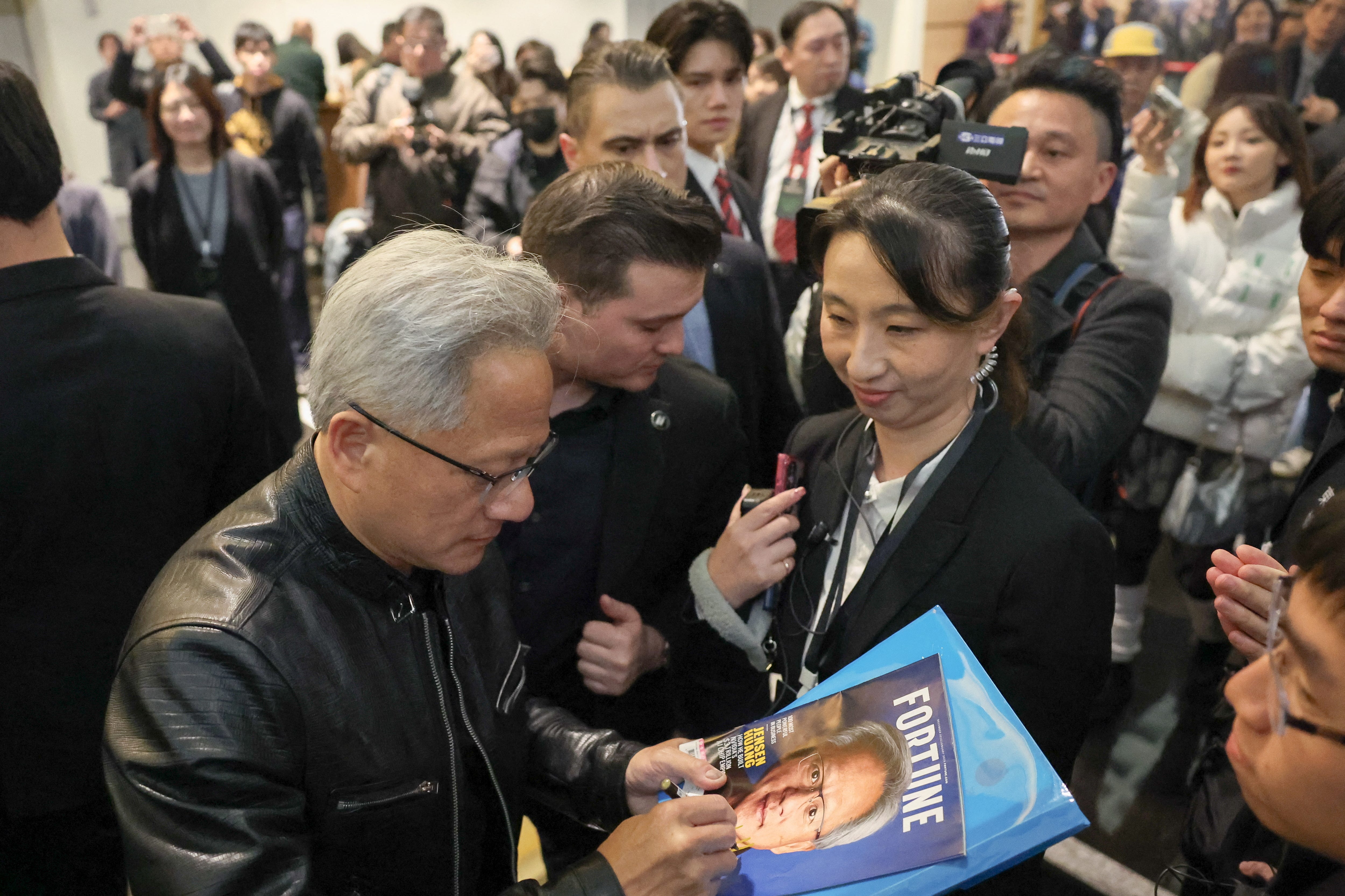 Nvidia CEO Jensen Huang signs autographs in Taiwan
