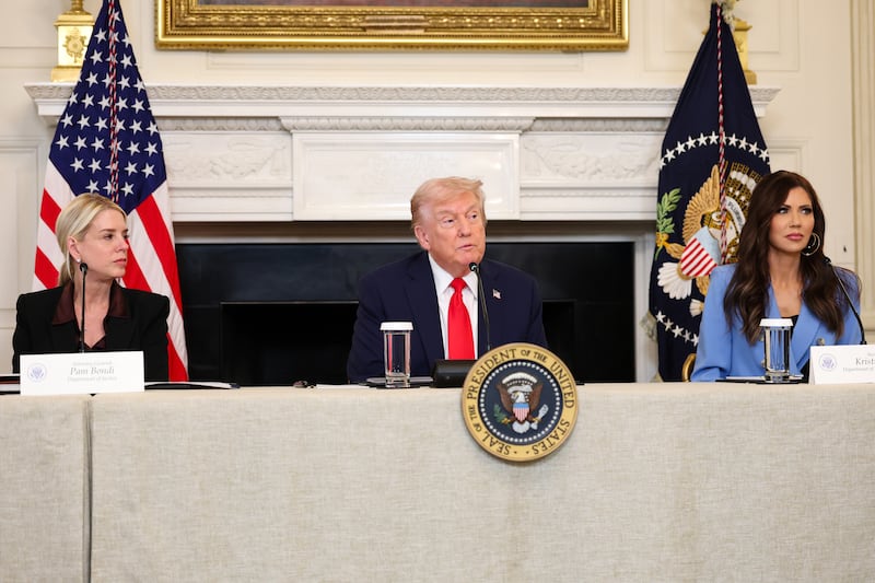 President Donald Trump (C) delivers remarks alongside U.S. Attorney General Pam Bondi (L) and U.S. Secretary of Homeland Security Kristi Noem during a roundtable discussion in the State Dining Room of the White House on October 08, 2025 in Washington, DC. Trump’s administration held the roundtable to discuss the anti-fascist Antifa movement after signing an executive order designating it as a “domestic terrorist organization”. (Photo by Anna Moneymaker/Getty Images)