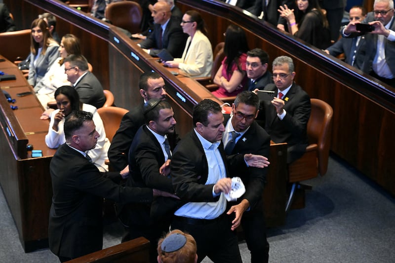 Israeli Knesset member Ayman Odeh being escorted out after interrupting Donald Trump's speech.