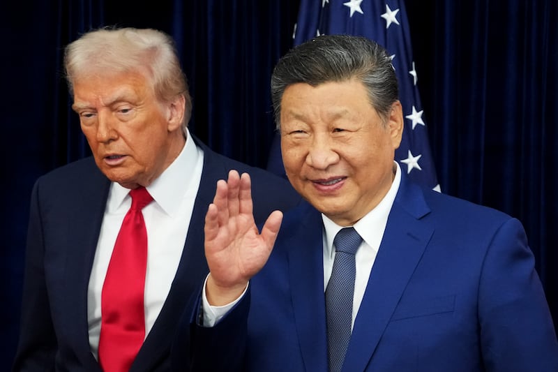BUSAN, SOUTH KOREA - OCTOBER 30: U.S. President Donald Trump and Chinese President Xi Jinping react after posing for photos ahead of a bilateral meeting at Gimhae Air Base on October 30, 2025 in Busan, South Korea. Trump is meeting Xi for the first time since taking office for his second term, following months of growing tension between both countries. (Photo by Andrew Harnik/Getty Images)