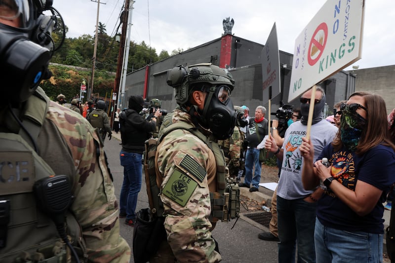 PORTLAND, OREGON - OCTOBER 04: Federal agents, including members of the Department of Homeland Security, the Border Patrol, and police, attempt to keep protesters back outside a downtown U.S. Immigration and Customs Enforcement (ICE) facility on October 04, 2025 in Portland, Oregon. The facility has become a focal point of nightly protests against the Trump administration and his announcement that he will be sending National Guard troops into Portland. A federal judge is currently hearing Oregon’s case against sending troops into the city, and a decision is expected on Saturday.  (Photo by Spencer Platt/Getty Images)