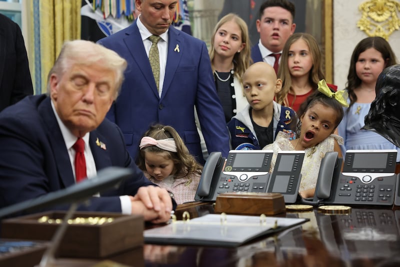 President Donald Trump (L) is joined by childhood cancer survivors and their families