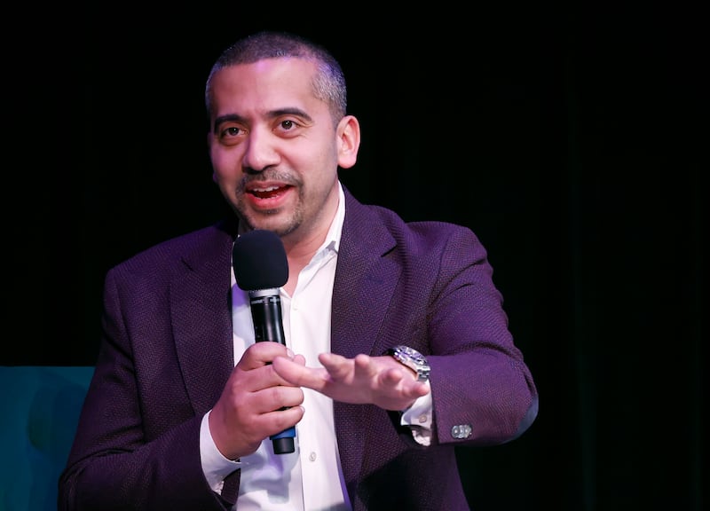 Medhi Hasan speaking with a microphone.