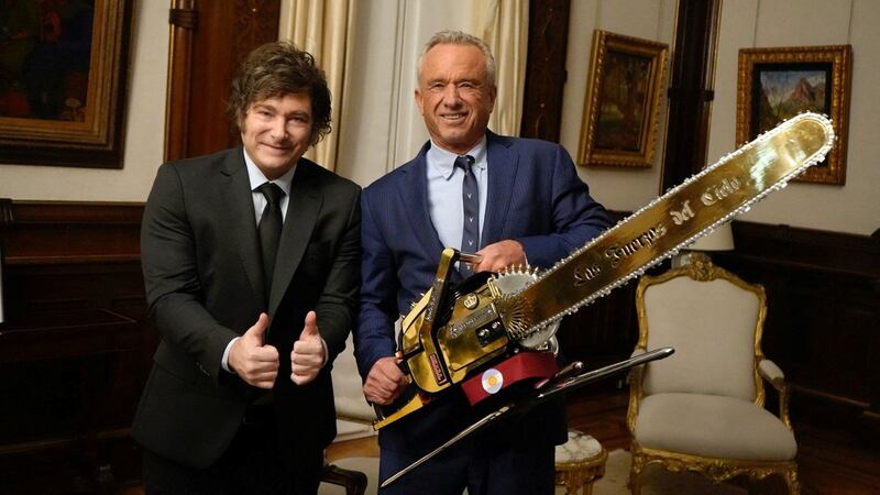 U.S. Health and Human Services (HHS) Secretary Robert F. Kennedy Jr. poses for a picture while holding a chainsaw that reads "Las fuerzas del cielo (the forces of heaven)" next to Argentine President Javier Milei, at the Casa Rosada Presidential Palace, in Buenos Aires, Argentina May 27, 2025. Argentine Presidency/Handout via REUTERS ATTENTION EDITORS - THIS IMAGE WAS PROVIDED BY A THIRD PARTY. NO RESALES. NO ARCHIVES