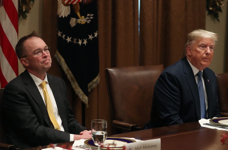 Donald Trump (R) and Mick Mulvaney (L) listen to comments during a luncheon with representatives of the United Nations Security Council, in the Cabinet Room at the White House on December 5, 2019 in Washington, DC.