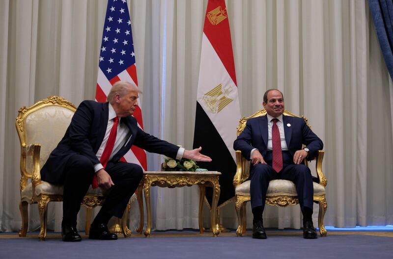 U.S. President Donald Trump reaches out to President of Egypt Abdel Fattah El-Sisi as they speak to the press