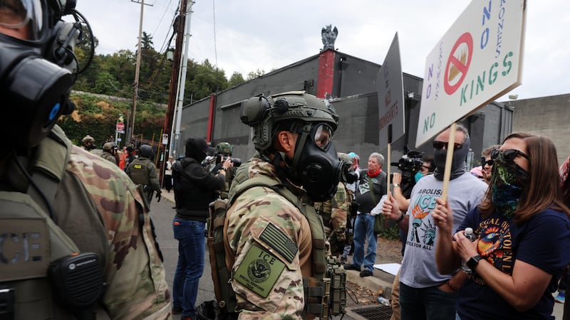 PORTLAND, OREGON - OCTOBER 04: Federal agents, including members of the Department of Homeland Security, the Border Patrol, and police, attempt to keep protesters back outside a downtown U.S. Immigration and Customs Enforcement (ICE) facility on October 04, 2025 in Portland, Oregon. The facility has become a focal point of nightly protests against the Trump administration and his announcement that he will be sending National Guard troops into Portland. A federal judge is currently hearing Oregon’s case against sending troops into the city, and a decision is expected on Saturday.  (Photo by Spencer Platt/Getty Images)