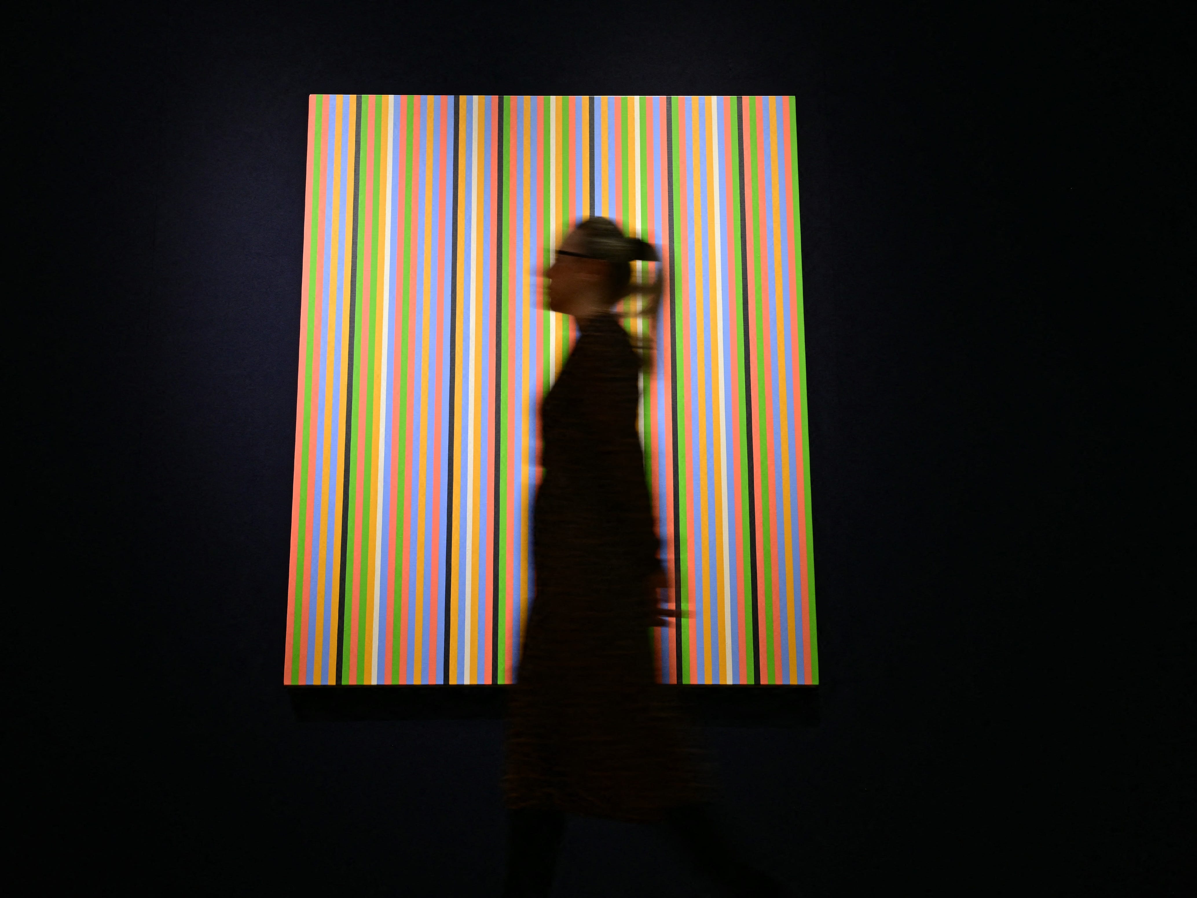 Woman in front of art at Christie's auction