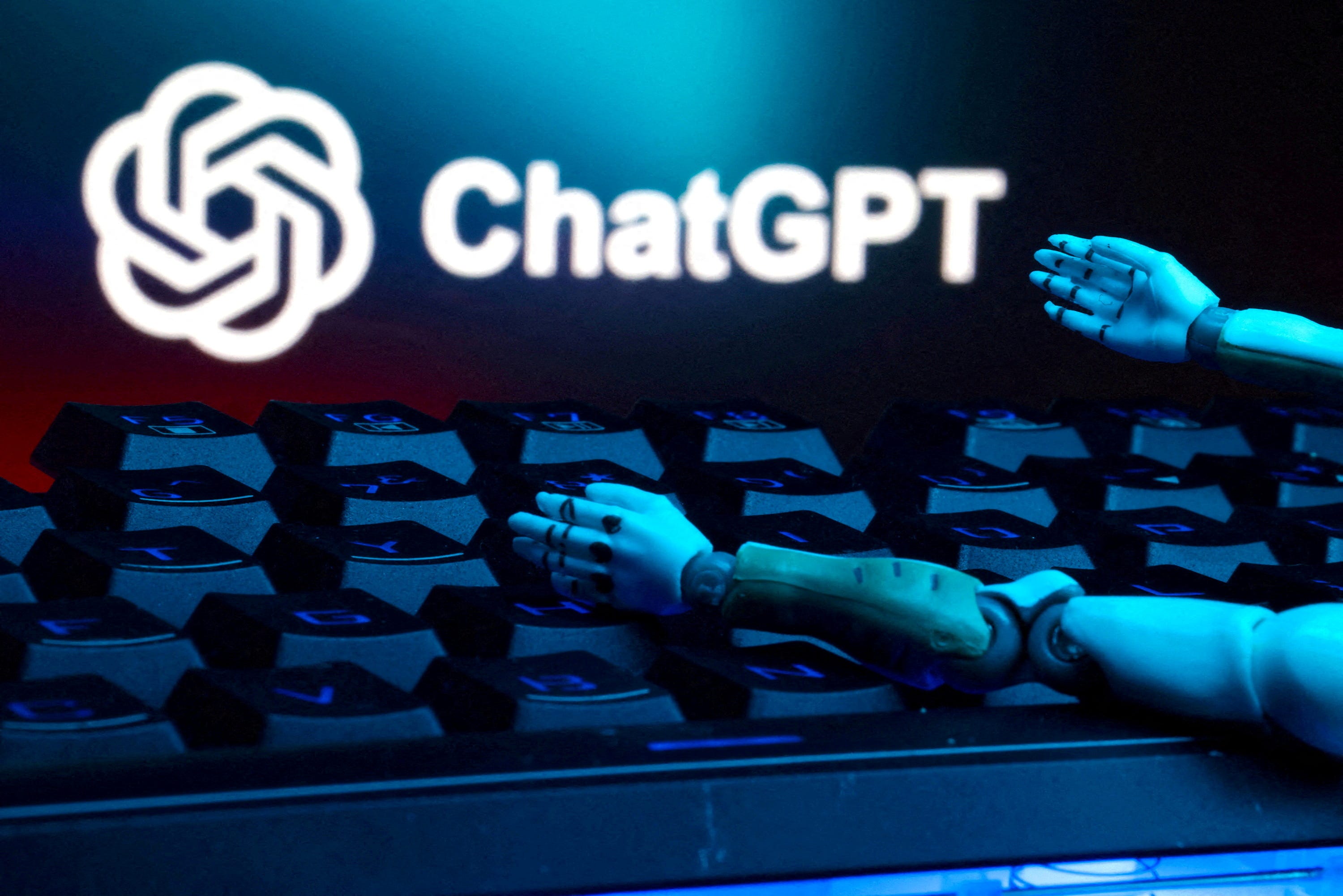 Illustration shows ChatGPT logo, keyboard, and robot hands