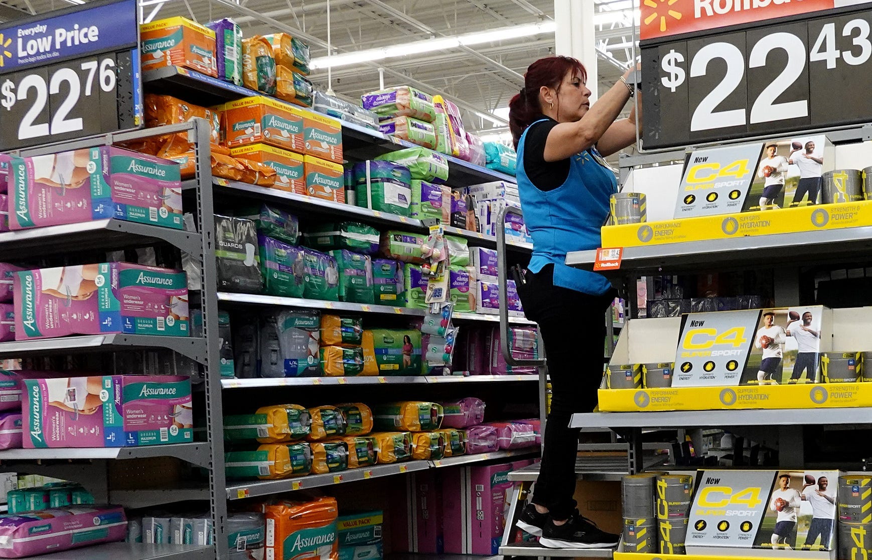 A worker stocks the shelves at a Walmart store on January 24, 2023 in Miami, Florida.