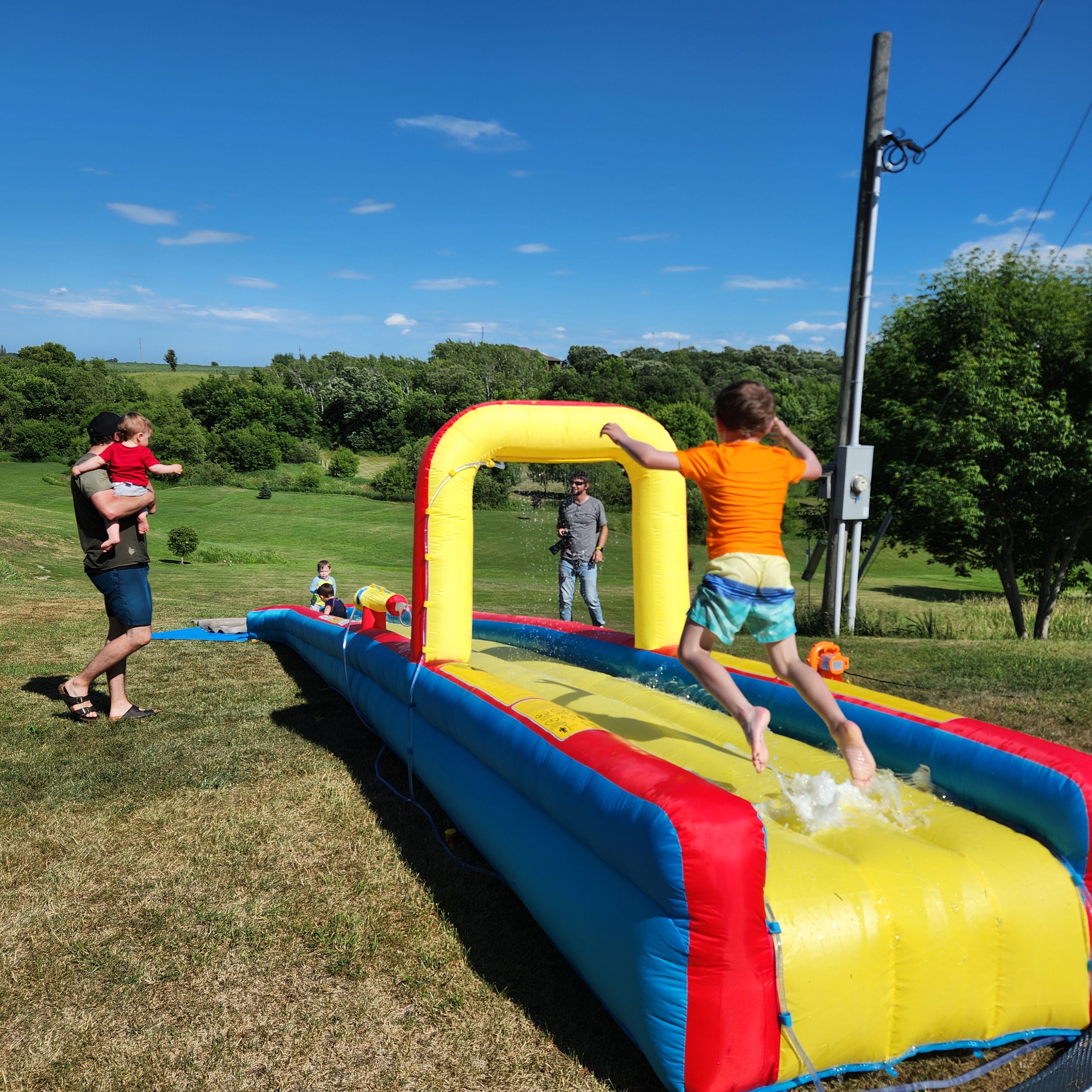 Kids playing on an inflatable slide